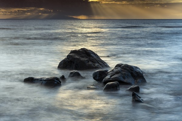 Rocks on the beach of Playa del Inglés. Sunset. Sea and waves. Long exposure. Valle Gran Rey, La