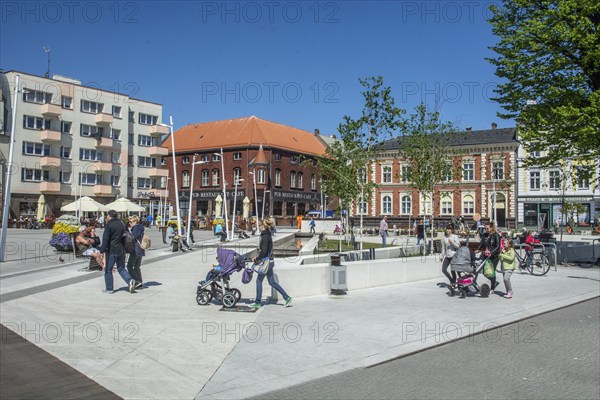People on the square in the modern center of Swinoujscie, Western Pomerania, Poland, Eastern