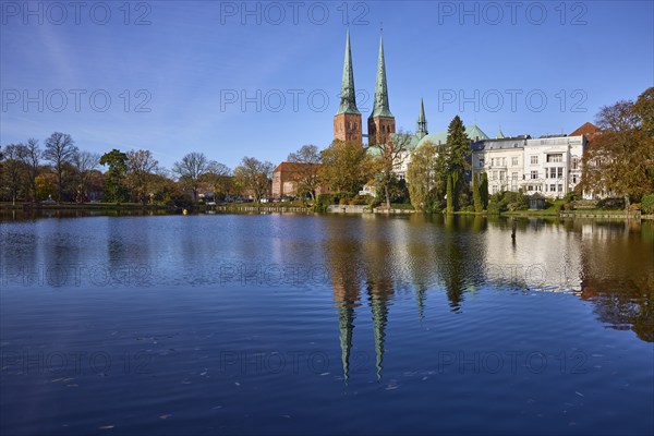 Mill pond with general buildings, Lübeck Cathedral and trees, symmetrical reflections on the water