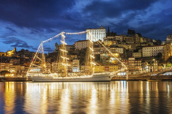 View of Porto city and Douro river with sailing ship from famous tourist viewpoint Marginal de Gaia