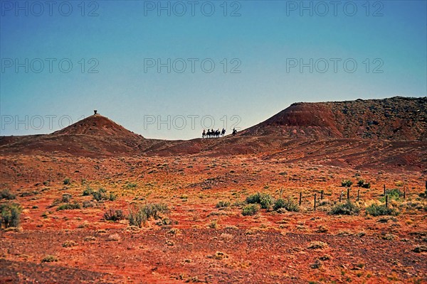 Cowboy group on the horizon, Monument Valley, Navajo Land, Colorado Plateau, under Navajo