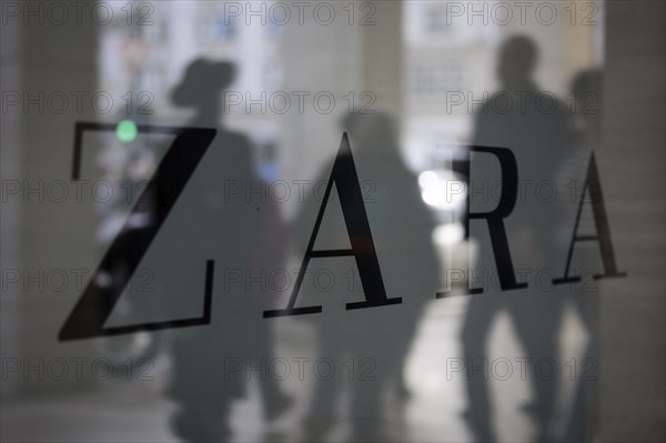 Company logo of the textile retail chain Zara, passers-by reflected in the shop window in Berlin,