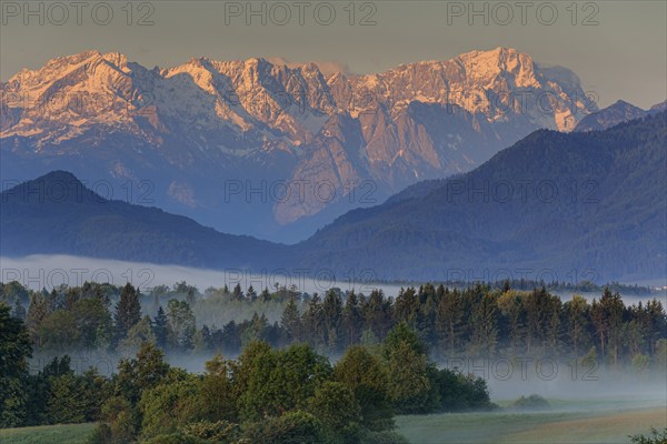 Morning fog over the foothills of the Alps, near Murnau, Wetterstein Mountains and Zugspitze in the