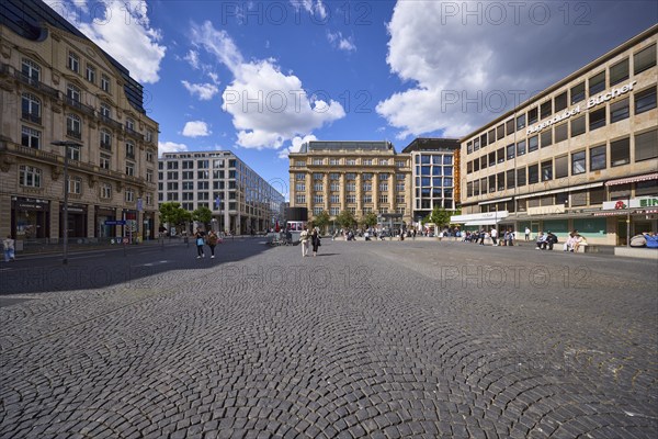 White and grey cumulus clouds with blue sky over Rathenauplatz in Frankfurt am Main, district-free