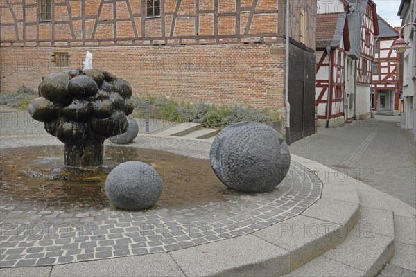 Mathildenbrunnen fountain with sculpture and balls, Butzbach, Wetterau, Hesse, Germany, Europe