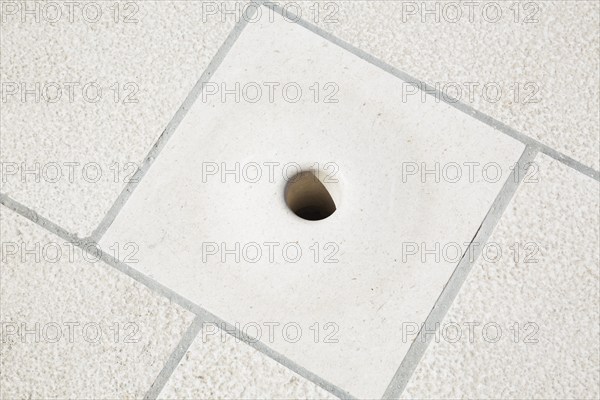 Close-up of hollowed out Sea Organ sound emitting hole in marble step created by architect Nikola