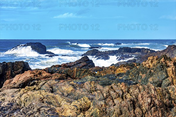 Waves crashing against the rocks on a rocky beach in Serra Grande on the southern coast of Bahia,