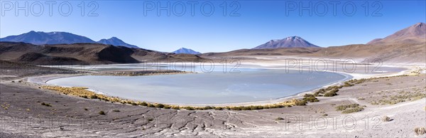 Panorama of Laguna Honda, lined with a few bushes, lagoon route, San Pedro de Quemes, Departamento