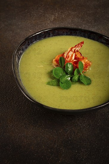 Pea cream soup, with shrimp, green soup, homemade, top view, no people