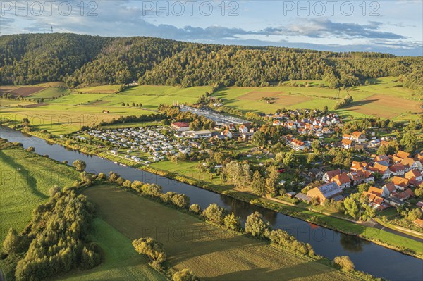 Aerial view of village Oedelsheim and the Weser river at sunset, traditional ferry, Weserbergland,