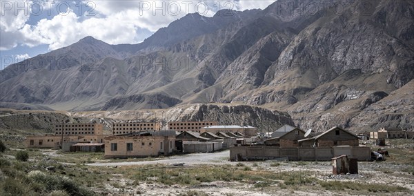Abandoned ruined buildings in a mountain landscape, ghost town, Engilchek, Tian Shan, Kyrgyzstan,
