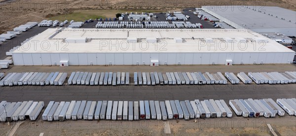 Los Lunas, New Mexico, A Walmart distribution center. Trucks wait their turn on the road outside