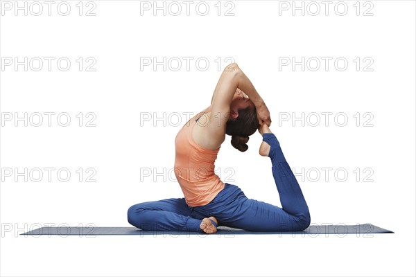 Woman doing Hatha yoga asana Eka pada rajakapotasana, one-legged king pigeon pose isolated