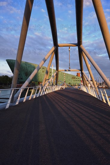 AMSTERDAM, NETHERLANDS, MAY 9, 2017: NEMO Science museum and Mr. J. van der Veldebrug bridge. It is