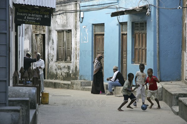 Black children playing in alley of the old medina of Stone Town, Stonetown, Mji Mkongwe, Zanzibar,