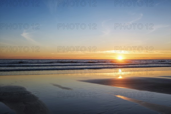 Atlantic ocean sunset with surging waves at Fonte da Telha beach, Costa da Caparica, Portugal,