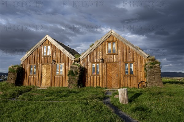 Traditional wooden peat houses with grass on the roof, in the evening light, Möðrudalur, Icelandic