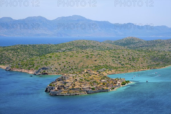 Island of Spinalonga with old fortress former leper colony and the bay of Elounda, Crete island,