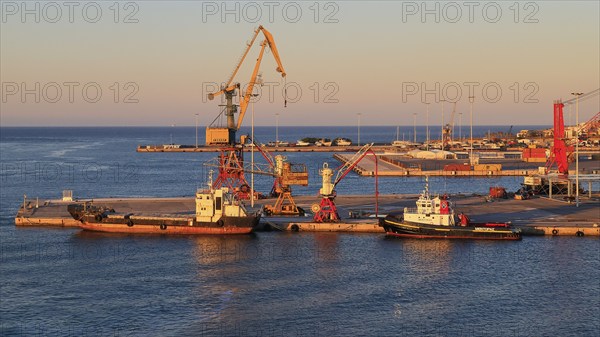 Evening light, pier, loading cranes, tugboats, port, Heraklion, capital, island of Crete, Greece,