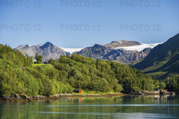 Fjord shore with mountains and Svartisen glacier, Helgeland coast, Nordland, Norway, Europe