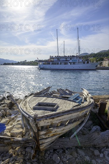 Old boat and behind it ship Meridijan, Kucište, Orebic, Pelješac Peninsula, Dubrovnik-Neretva