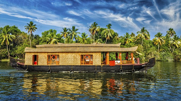 Travel tourism Kerala background, panorama of tourist houseboat on Kerala backwaters. Kerala,