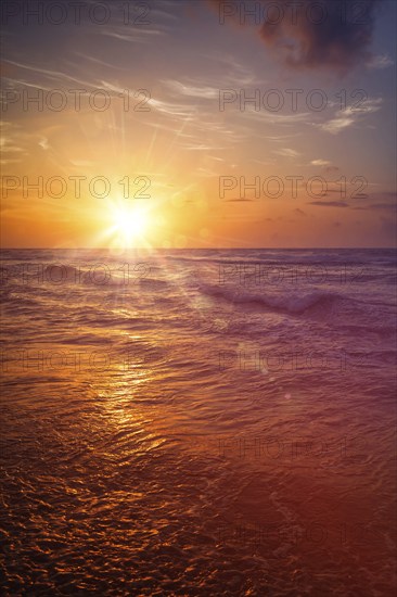 Ocean sunset, Hikkaduwa, Sri Lanka. With light leak and lens flare