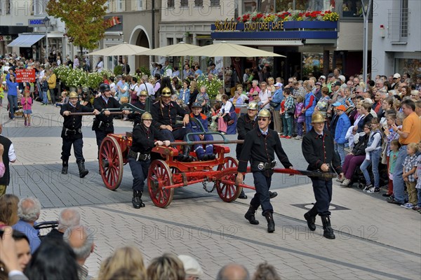 Historical firemen in uniform with an engine parading at Zwetschgenfest, plum festival, Bühl,
