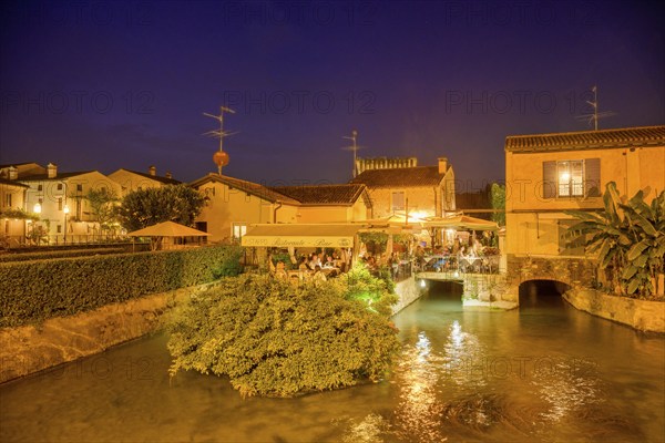 Night shot of a pub on the Mincio River, Valeggio sul Mincio, Province of Verona, Italy, Europe
