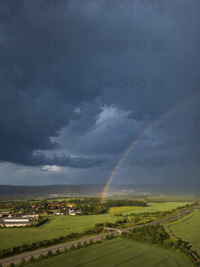 Thunderstorm cell with rainbow over fields near Krebs in the Osterzgebirge, Krebs, Saxony, Germany,