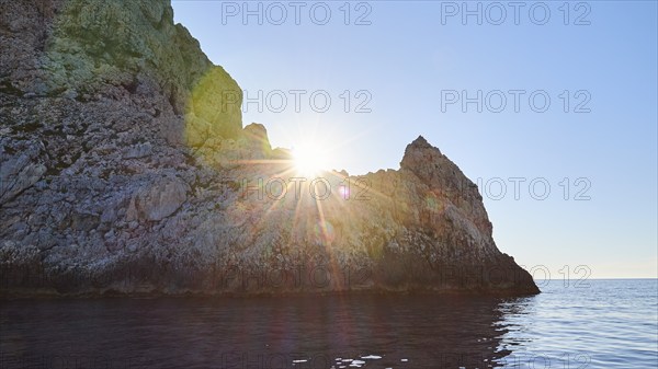 Evening light, sunset, sun as star, sun behind rocks, Marettimo, Egadi Islands, Sicily, Italy,