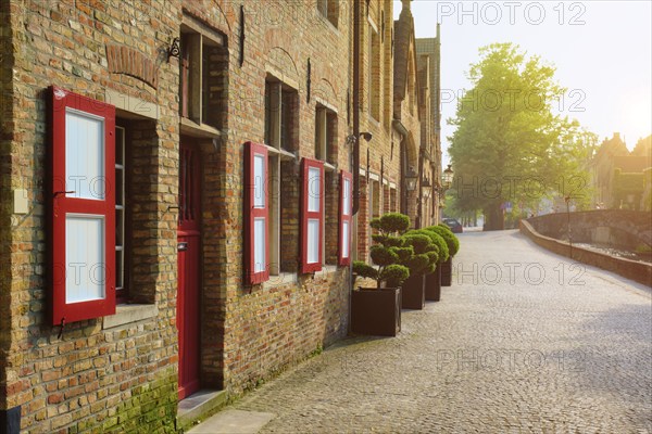 Door and windows of an old houses and street on sunset, Bruges (Brugge), Belgium, Europe