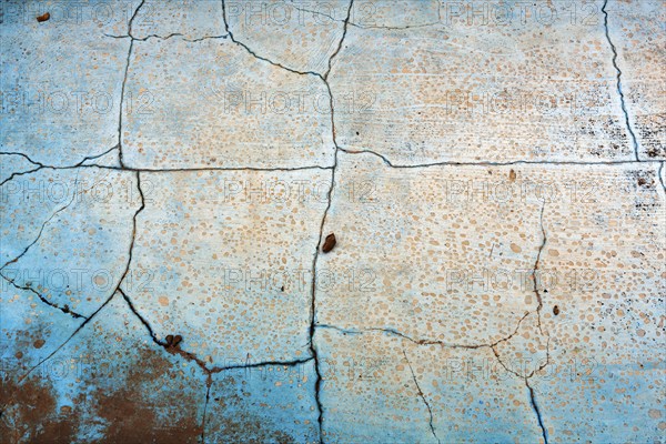 Dirty broken floor in a swimming pool, cracks, peeling paint, dilapidated swimming pool, lost