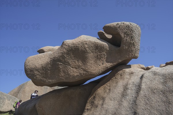 Tourists visiting strange rock formations due to wind and water erosion along the Côte de granit