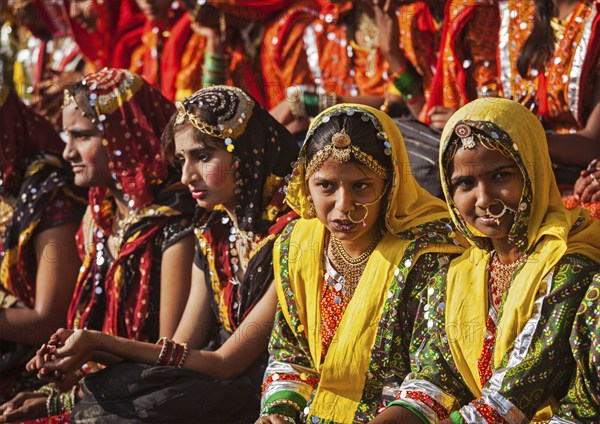 PUSHKAR, INDIA, NOVEMBER 21, 2012: Unidentified Rajasthani girls in traditional outfits prepare for