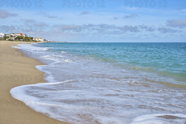 Breaking waves on a sandy beach, sunny, near Tarragona, Catalonia, Spain, Europe