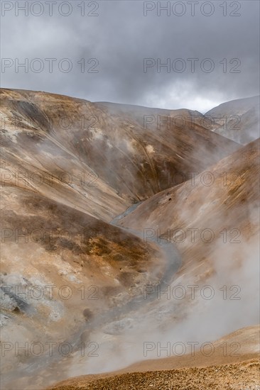 Steaming stream between colourful rhyolite mountains, Hveradalir geothermal area, Kerlingarfjöll,
