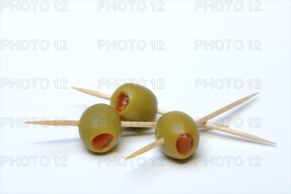 Green olives on toothpicks, stuffed with pieces of paprika