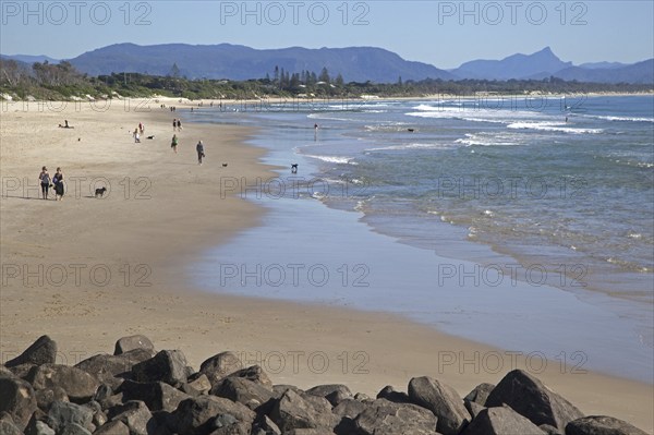 Tourists strolling on the beach at Byron Bay along the Coral Sea, New South Wales, Australia,