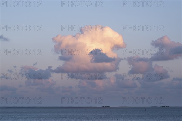 Clouds in the evening light over the North Sea, in the background the Halligen, Wyk, Föhr, North