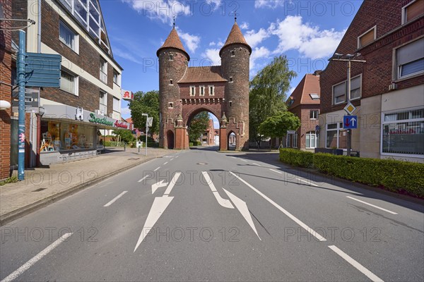 Historic city gate Lüdinghauser Tor against blue sky with cumulus clouds and Lüdinghauser Strasse