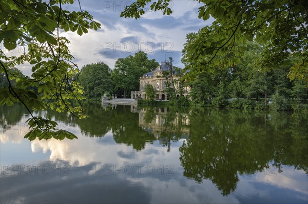 Seeschloss Monrepos is reflected in Lake Eglosheim, Ludwigsburg, Baden-Württemberg, Germany, Europe