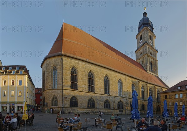 Lively market square with cafés and St Martin's Basilica in the evening light, Amberg, Upper