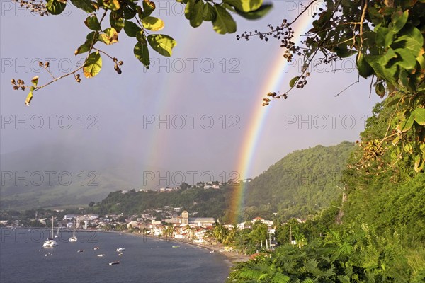 Double rainbow over beach and the town Saint-Pierre, first permanent French colony on the island of