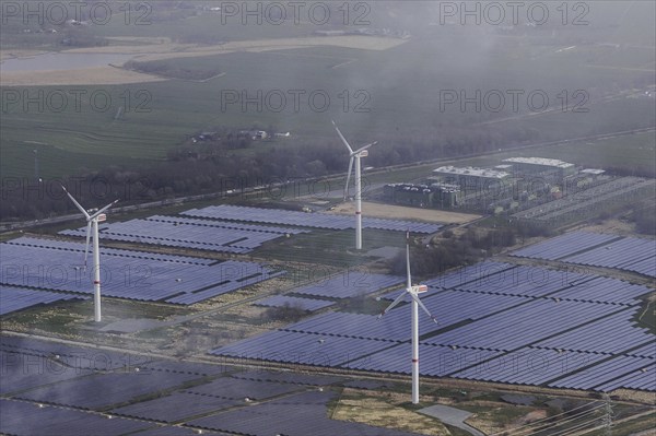 Aerial view of wind turbines and solar installations, taken near Wischhafen, 25/03/2024