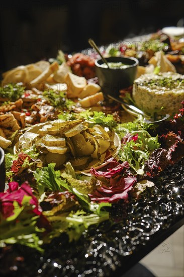 A table is beautifully arranged with a variety of Middle Eastern appetizers, featuring fresh herbs,
