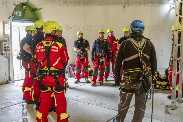 Height rescuers from the Oberhausen fire brigade practise abseiling from a wind turbine from a