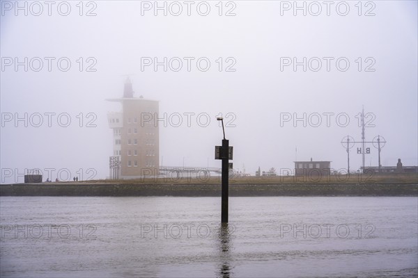 Thick fog in winter, hanging over the mouth of the Elbe into the North Sea, radar tower of the
