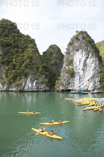 Yellow kayaks at a jetty and the karst rocks in Lan Ha Bay, Halong Bay, Vietnam, Asia
