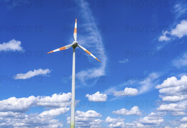 Wind turbine, wind energy plant from the manufacturer Enercon, blue sky with many white clouds,